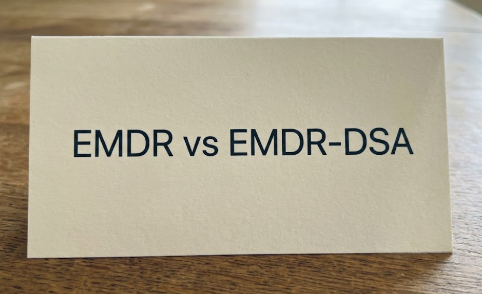 Carte en papier affichant “EMDR vs EMDR-DSA”, illustrant la comparaison entre l’EMDR classique et l’approche EMDR-DSA
